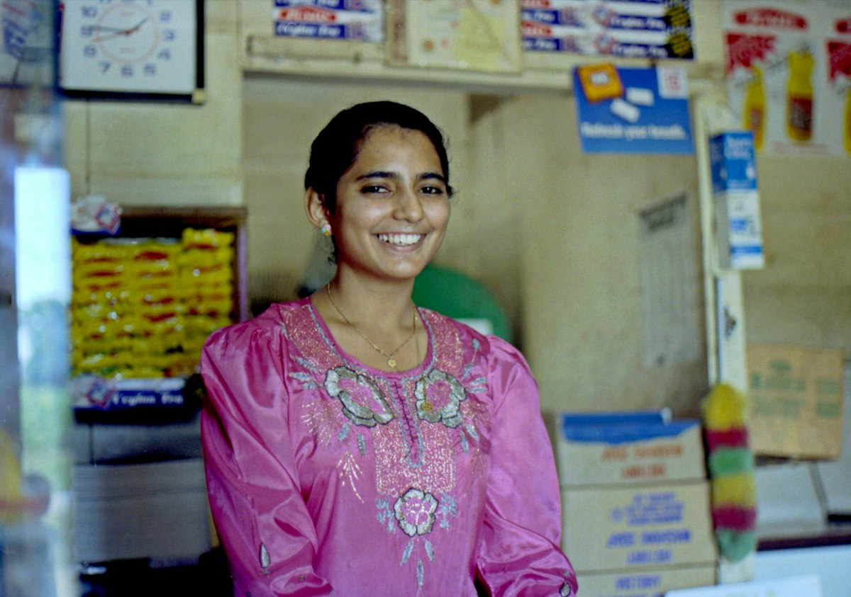 Shop owner smiling at her counter